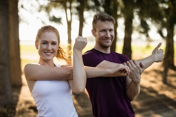 Smiling couple exercising at farm