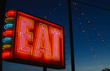 © Raymond Forbes LLC/Stocksy - Eat neon sign at night