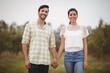 © wavebreak3 - Smiling young couple holding hands at olive farm