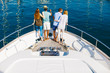 © BONNINSTUDIO/Stocksy - Group of friends enjoying a sunny day on a luxurious yacht