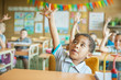 © Lumina/Stocksy - Primary School Students Raising Hands