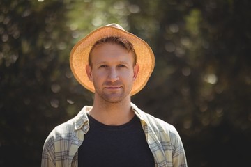 Handsome young man wearing hat on sunny day at olive farm