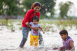 © Saptak Ganguly/Stocksy - Family enjoying hot summer day in the river