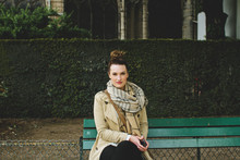Yound Woman Sits On Bench