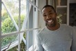 © WavebreakMediaMicro - Portrait of smiling man standing by window