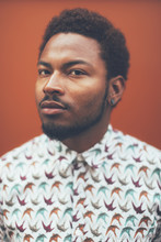 Portrait Of Modern Young Black Man In Front A Orange Wall