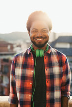 Portrait Of An African American Man Smiling On A Terrace At Sunset
