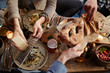 © Trinette Reed/Stocksy - Group of friends having dinner together inside a cabin