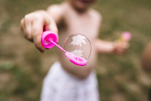 Child Playing With Bubble Soap