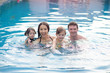 © ID_Anuphon - member of happy family enjoy in public swimming pool