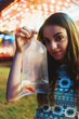 © Chelsea Victoria/Stocksy - A young girl holding a prize fish at a carnival