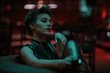 © Boris Jovanovic/Stocksy - Close up of a beautiful woman with attitude sitting in the bar at night