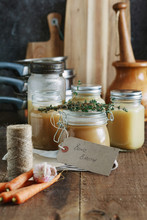 Bone Broth In Glass Jars On A Wooden Table