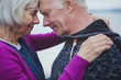 © Rob and Julia Campbell/Stocksy - Sincere senior couple leaning foreheads together outside near water