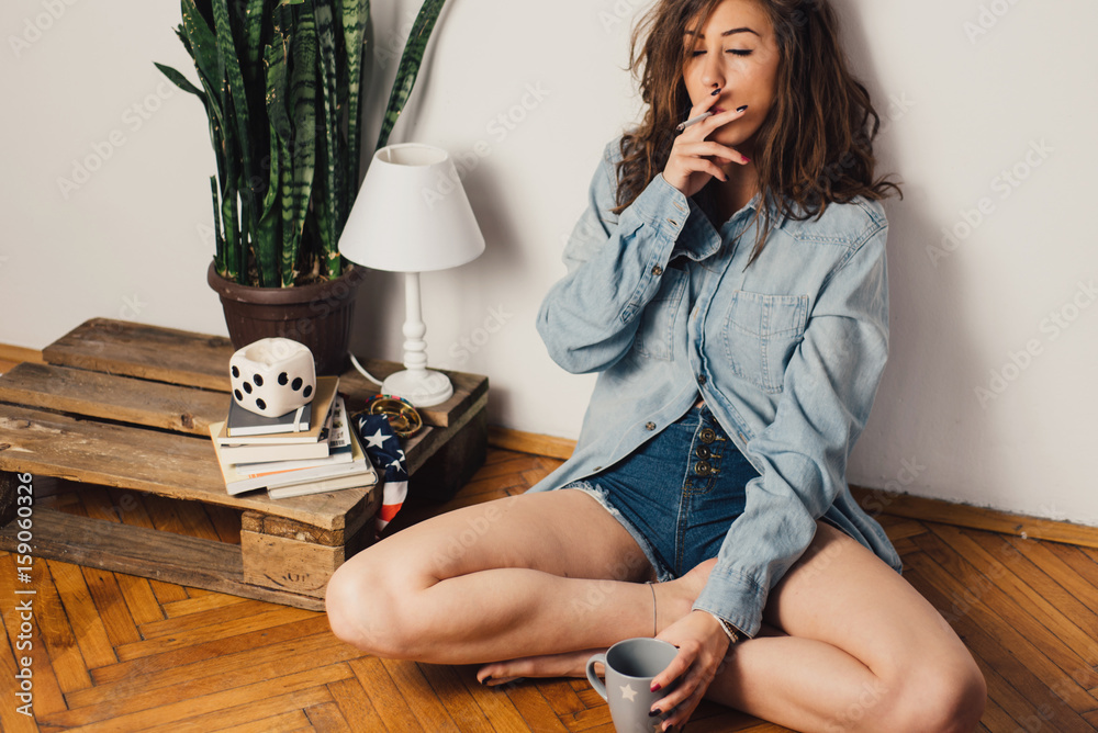 Beautiful woman smoking a cigarette Stock Photo | Adobe Stock