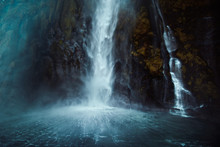 The Rushing Waterfall Splashes Into A Cold New Zealand Sound