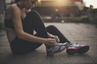 © Lumina/Stocksy - Sportswoman Tying Shoelaces