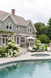 © Raymond Forbes LLC/Stocksy - Modern home with backyard swimming pool