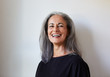 © Trinette Reed/Stocksy - Portrait of beautiful senior woman with grey hair indoors