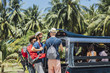 © Lumina/Stocksy - Tourists Enjoying a Taxi Ride in a Tropical Country