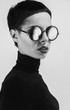 © Marko Milanovic/Stocksy - Black and white conceptual portrait of female model with sunglases