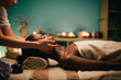 © Lumina/Stocksy - Woman receiving a head massage at spa