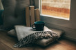 © BONNINSTUDIO/Stocksy - Coffee time in a cozy home on a rainy day