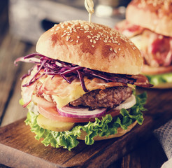 Wall Mural - Delicious homemade hamburger on wooden background.