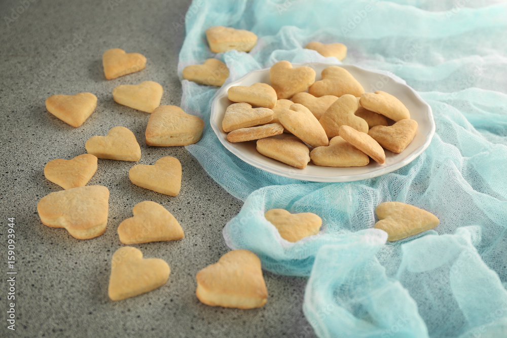 Plate with heart shaped butter cookies on table