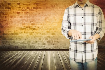 Poster - Composite image of mid section of man using digital tablet