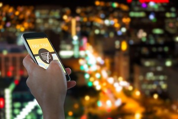 Wall Mural - Composite image of close-up of hand holding mobile phone