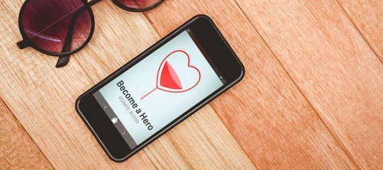 Poster - Composite image of become a hero text with heart shape on screen
