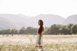 © boykovi1991 - Woman enjoying a field of daisies, beautiful woman lying in a meadow of flowers, beautiful girl relaxing outdoors, having fun, holding plant, happy young lady and spring-green nature, harmony concept.
