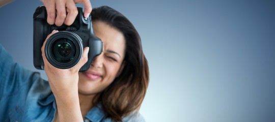Poster - Composite image of young woman photographing through camera
