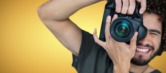 Poster - composite image of smiling male photographer taking picture