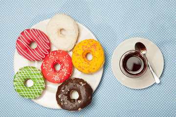 Wall Mural - Cup of tea and donuts on a blue table