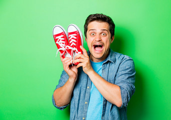 Wall Mural - Handsome smiling man with red gumshoes