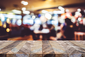 Aufkleber - Empty old grunge wood plank table top with blur people dinner in restaurant bokeh background,Use for display for montage of product