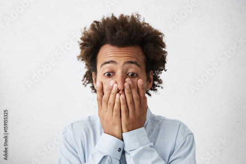 Depressed Full Of Disbelief Mixed Race Man With Bushy Hair Wearing