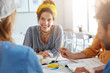 © wayhome.studio  - Cooperation and teamwork concept. College students sitting together having working atmosphere surrounded with books and papers discussing their future project having pleasant smiles and expressions
