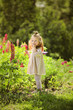 © biotin - Portrait of little Little red hair girl playing in lupines field. Ginger sunny kid has fun in the garden surrounded by lush and flowers sunny day