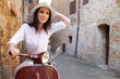 © ZoomTeam - beautiful girl in a hat in a white t-shirt and hat posing on a vintage scooter in Italy fashion clothing and accessories bracelet on her arm