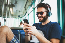 Young Man Riding In Public Transport Listening To The Music