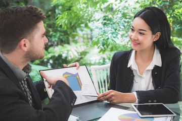 Wall Mural - Businessman meeting with business woman at office to discuss marketing situation 