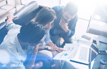 Business meeting concept.Coworkers team working new startup project at modern office.Analyze business documents, laptop on table.Blurred background.Horizontal