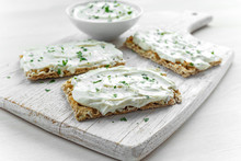 Homemade Crispbread Toast With Cream Cheese And Parsley On White Wooden Board Background.