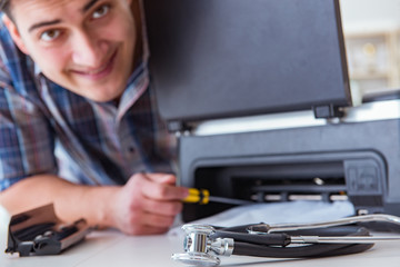 Repairman repairing broken color printer