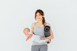 © Iryna - Sport, motherhood and active lifestyle concept - happy charming sporty mother holding cute little baby boy in one hand and yoga mat in the other while standing on white background.