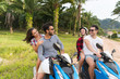 Two Couple Riding Motorbike, Young Man And Woman Travel On Bike On Tropical Forest Road During Exotic Summer Holiday