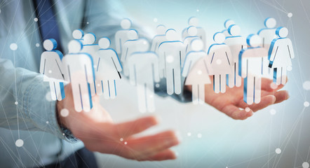 Aufkleber - Businessman holding 3D rendering group of people in his hand